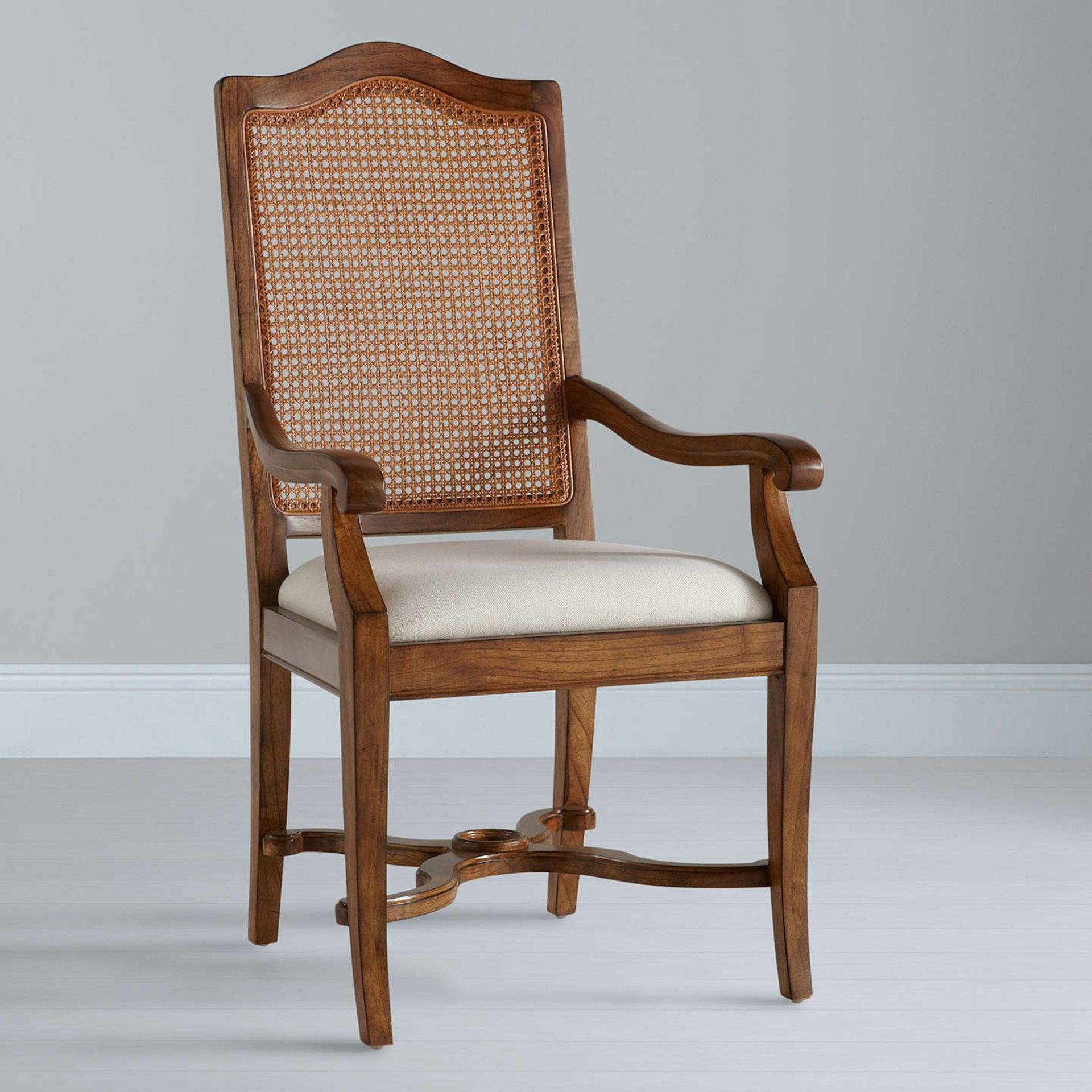 A Pair of JL Hemingway Cane Back Arm Chair Pippy oak features small, tight clusters of knots,