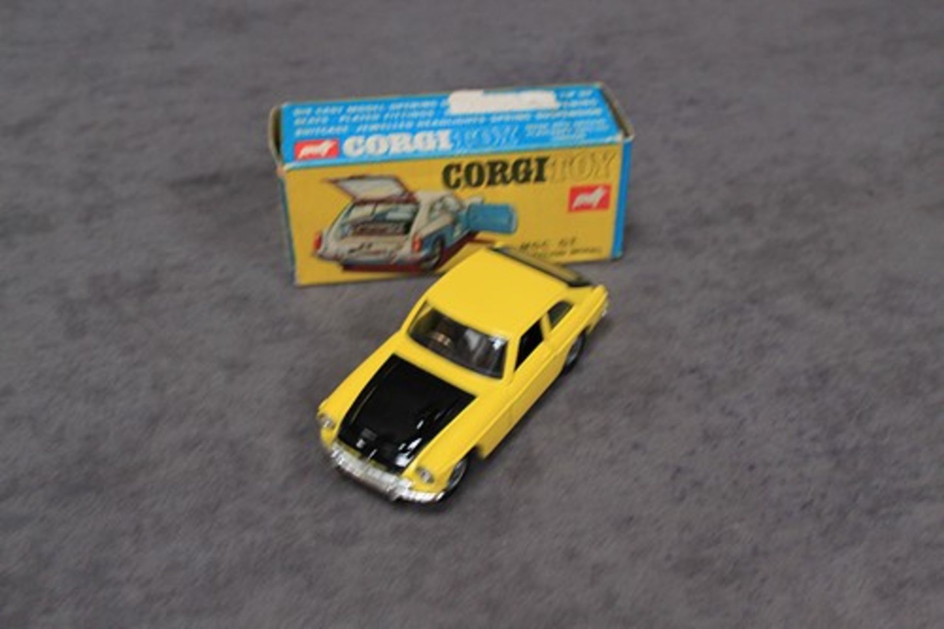 Mint Corgi Toys Diecast #345 MGC GT Competition Model in Yellow & Blackwith suitcase in a very good