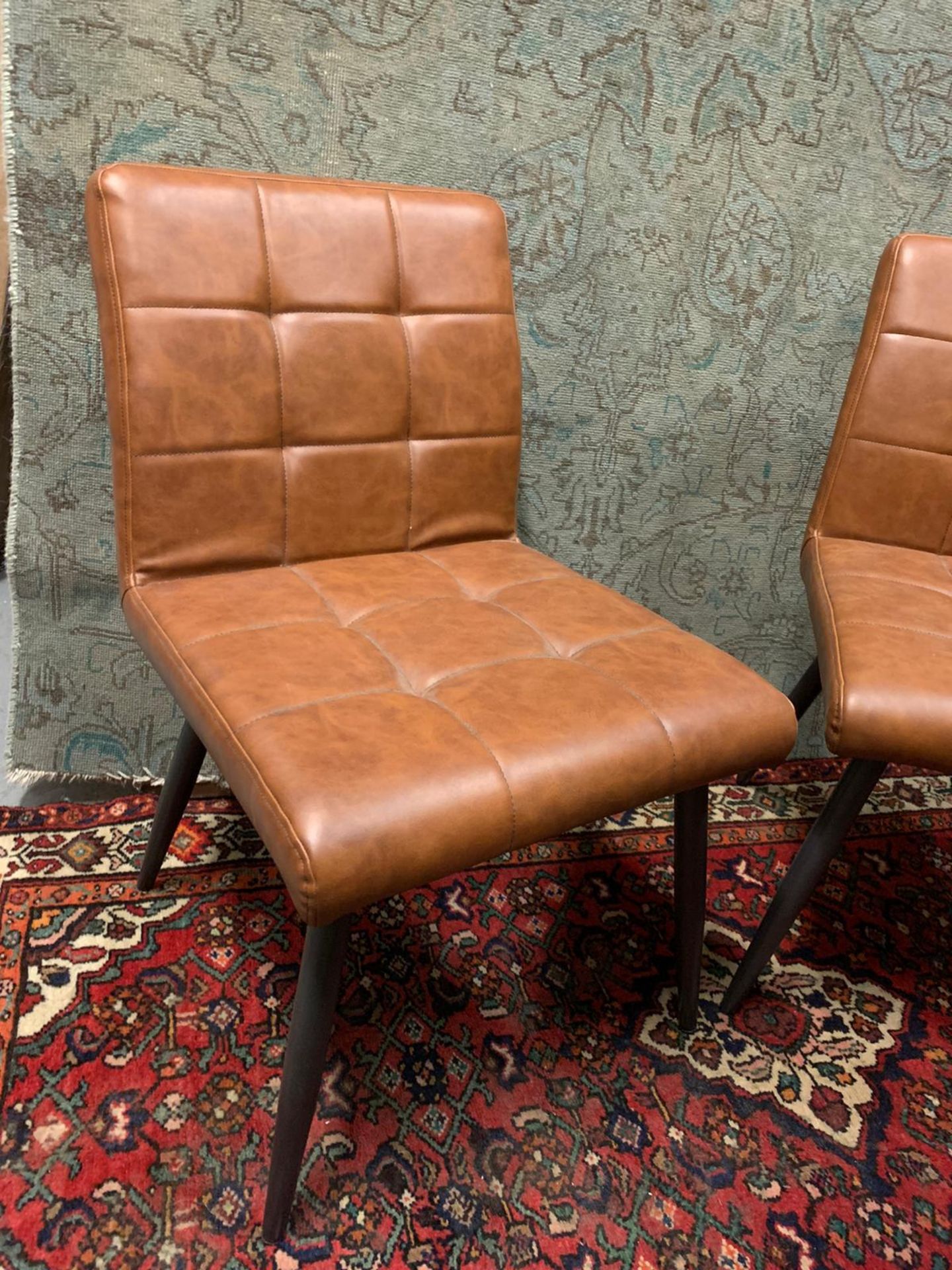 A set of 4 x Barca dinging chairs Brown With cushioned and tufted upholstery, four round and tapered