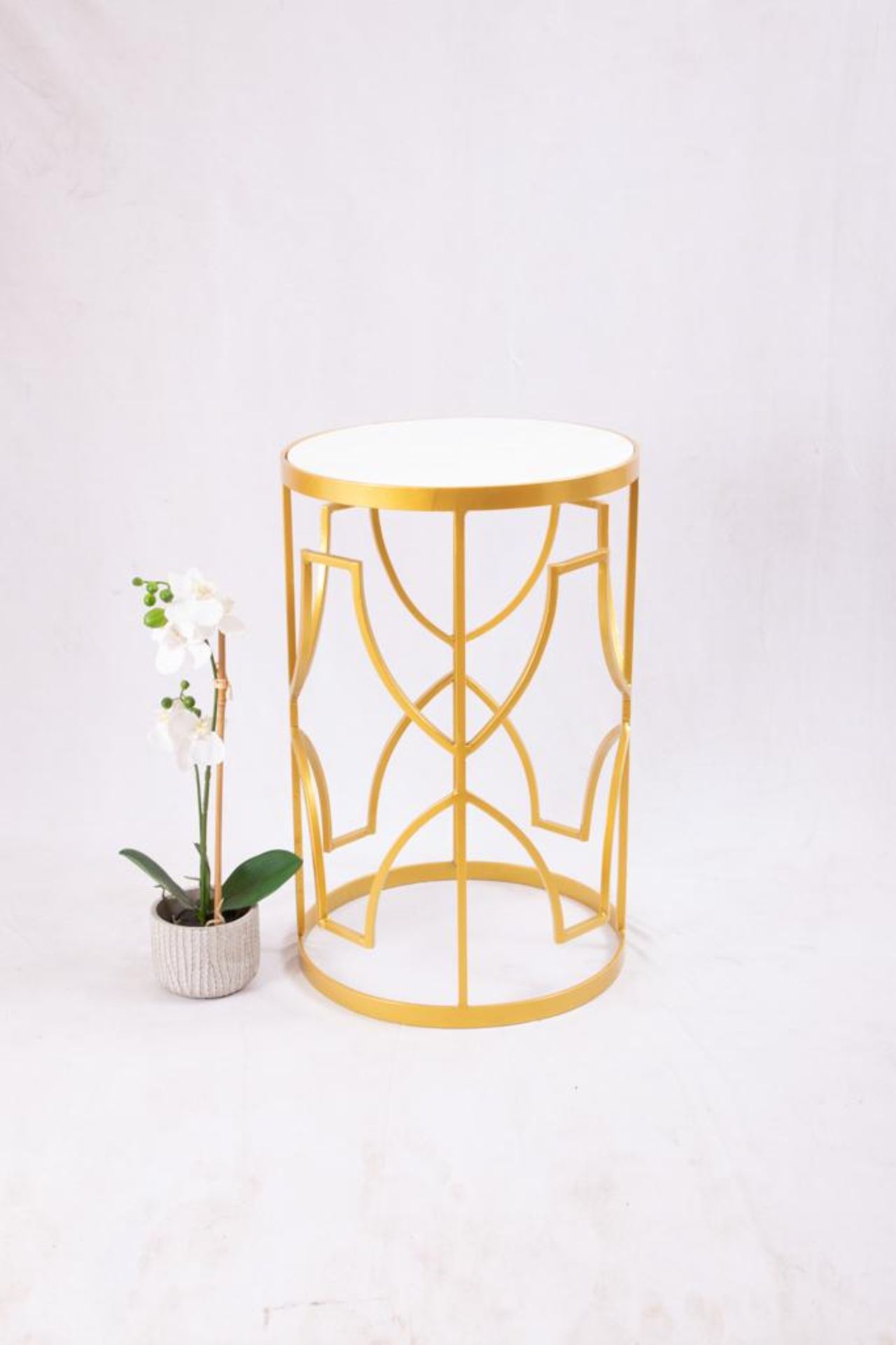 A gorgeous side table finished in a bright gold coating and a stunning white marble top. Style type: