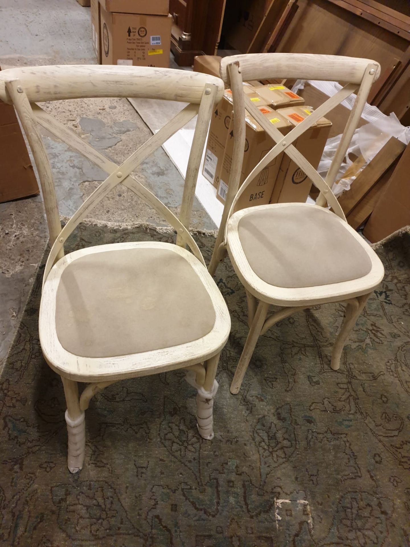 **Clearance Bargain** A pack of 2 understated cross back chairs in a distressed white wood finish