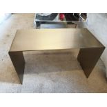 A brushed steel waterfall single piece side table constructed of solid stainless steel in brushed