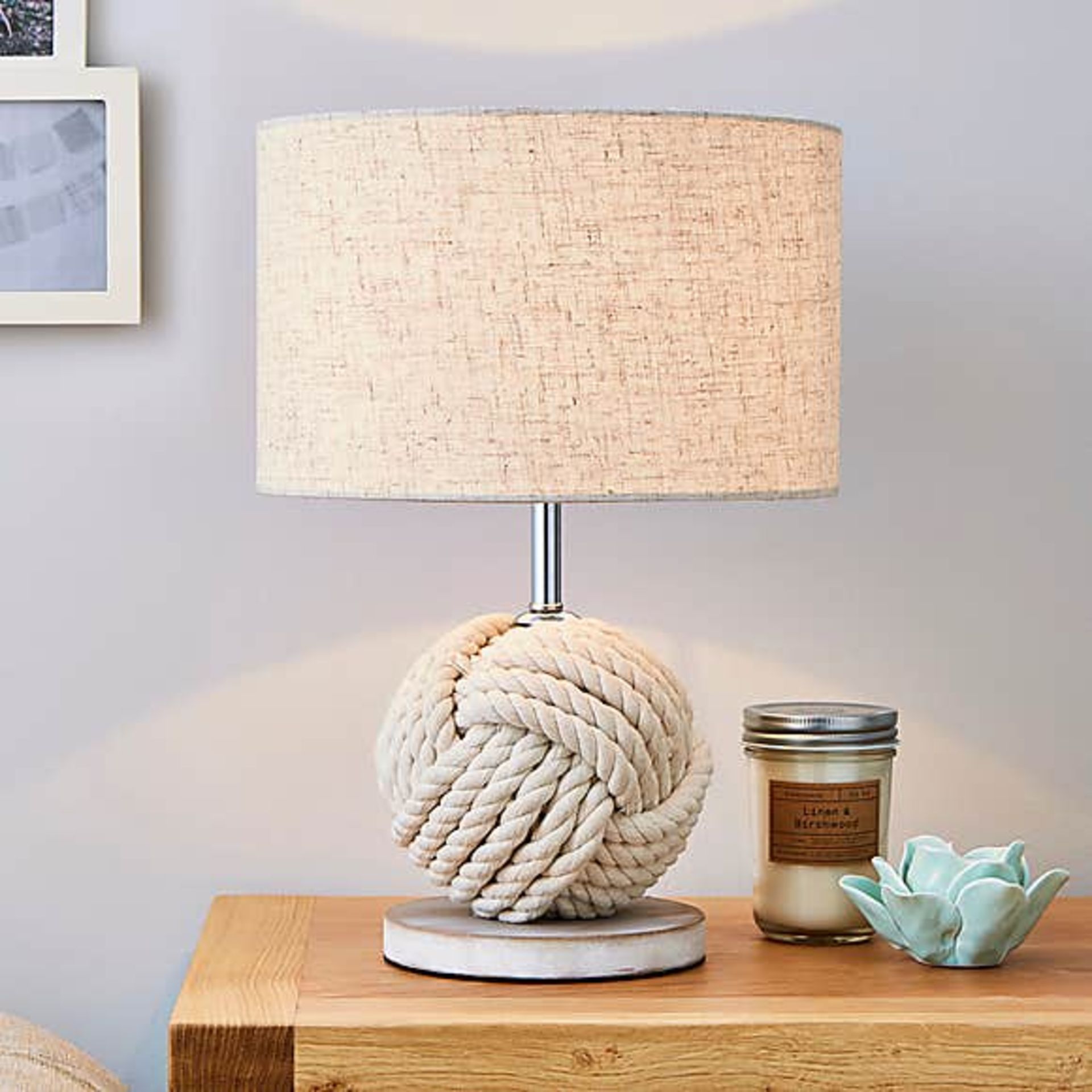 A pair of Lina table lamp features a white washed rope knotted into a ball to create a unique lamp