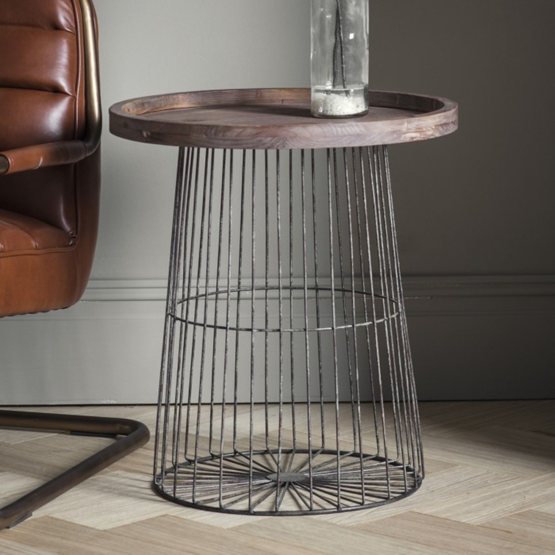 Menzies Side Table The Menzies side table features a caged gun-metal frame and base with a weathered