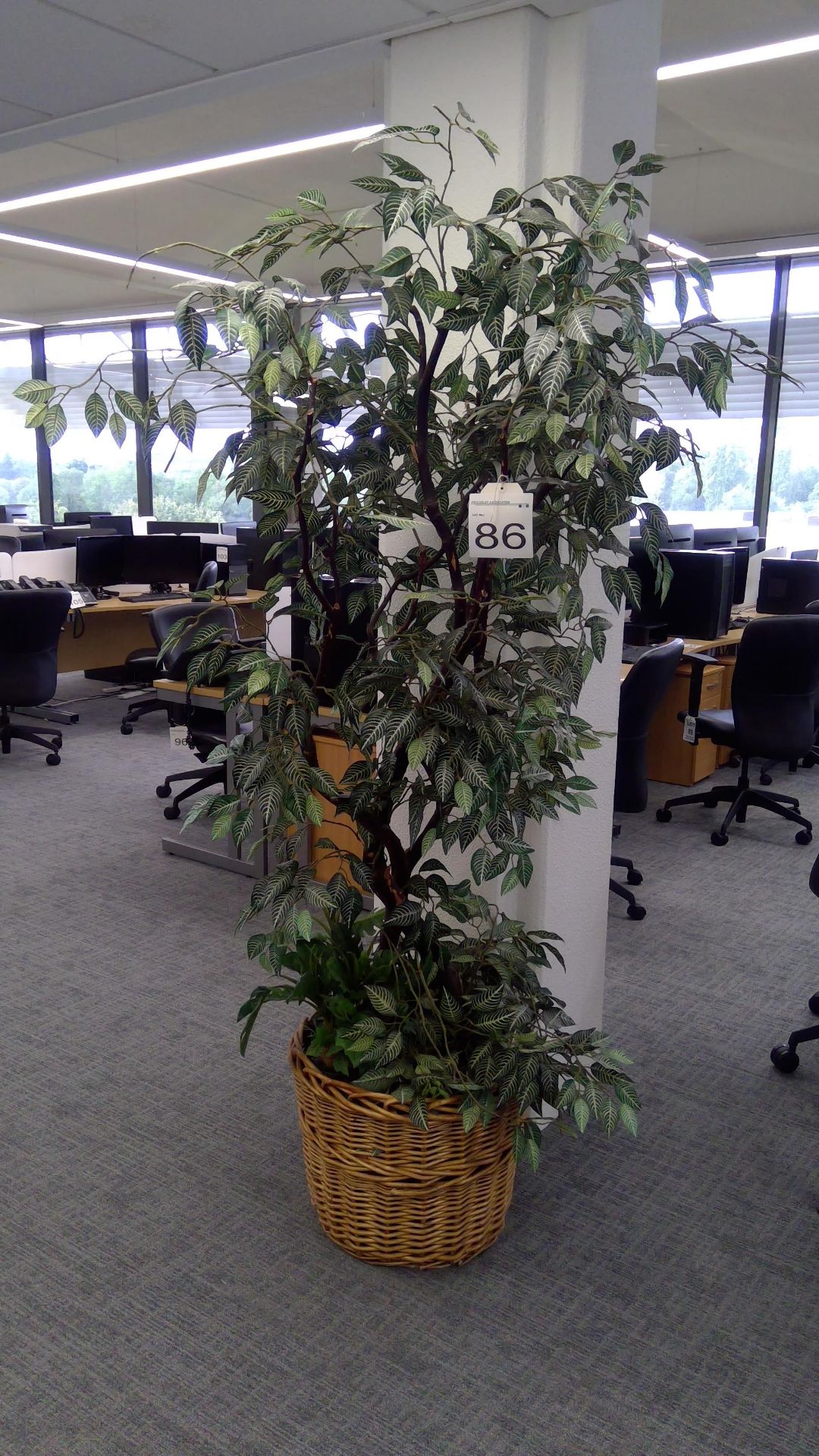 Artificial plant display in wicker basket