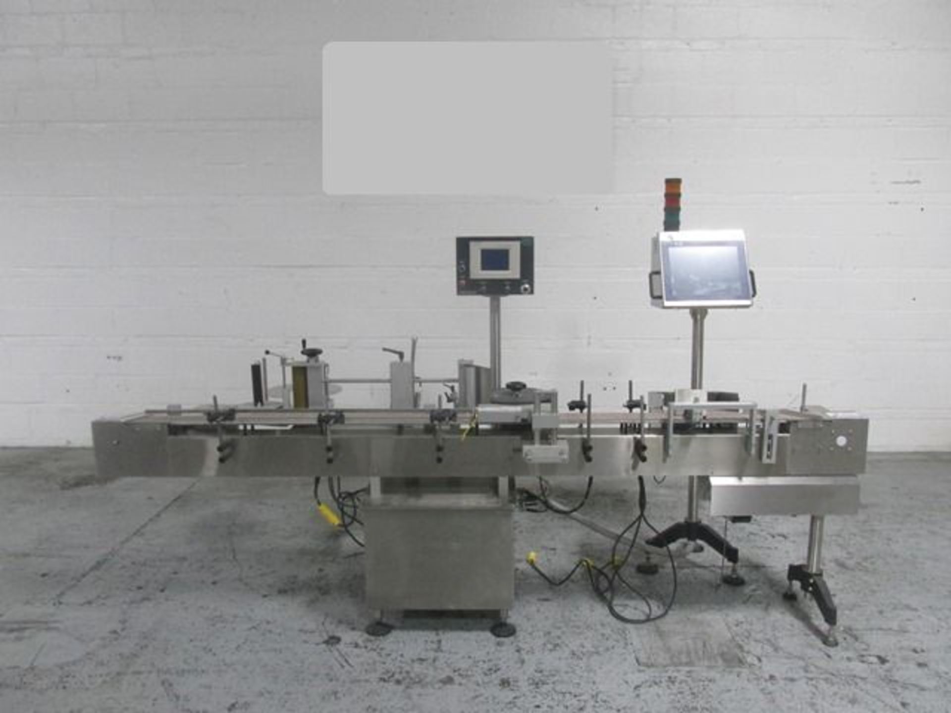 Used New Jersey wrap around labeler, model UNI300V-S007, with Optel vision system, model Optel