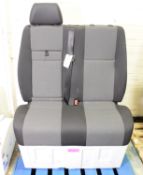 Twin Vehicle Seats With Seat Belts.