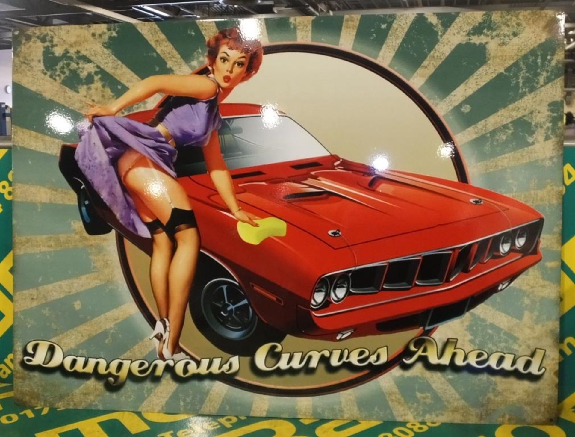 Dangerous Curves Ahead tin sign