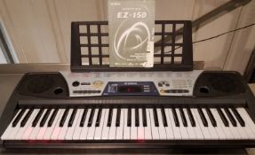 Yahama EZ-150 piano keyboard with light-up keys, demo instructional songs, 99 instrument t