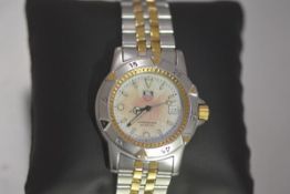 A mid-size Tag Heuer stainless steel wristwatch, the white and pink dial with baton numerals, with