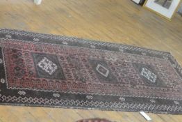 A Yamud rug, the centre panel with triple diamond shaped medallions enclosed within a leaf and