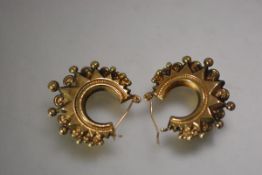 A pair of late Victorian 9ct gold hoop earrings, of star outline with beaded rim, with hinged post