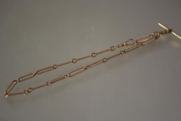 A late Victorian 9ct gold watch chain, of elongated oval links, with lobster clasp and t-bar. Length