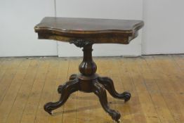 A mid-Victorian burr walnut foldover card table, the cartouche top opening to a baize lined interior