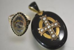 A 19th century seed-pearl mounted black enamel pendant locket, mounted in yellow metal, centred by a