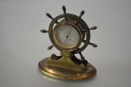 A late Victorian brass desk barometer, modelled as a ship's wheel, the wheel enclosing a silvered