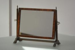 A small George III mahogany toilet mirror, early 19th century, the rectangular mirror plate within a