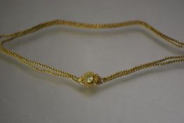 A twin strand gold chain necklace, of reeded round links, on an elaborate clasp centred by an oval-