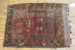 A Kurdish nomadic bag face rug, with stylised floral centre panel and floral border. 90cm by 66cm