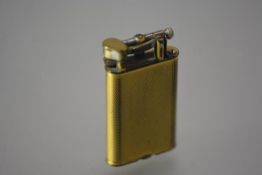 A Dunhill Unique gold-plated pocket lighter, the case with engine-turned decoration, pat. no. 143752