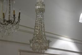 A Continental cut-glass basket chandelier, mounted in white metal, with gilt chain over two