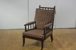 A mahogany bobbin-turned armchair, mid-19th century, with turned elements throughout, stuffed-over