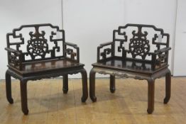 A handsome pair of Chinese carved throne chairs, c. 1900, probably padouk wood, each with stepped