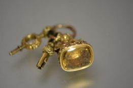 A good 19th century yellow metal fob seal, the carved citrine matrix engraved with the arms of