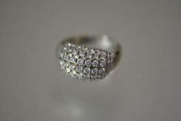 A diamond bombe ring, set with seven rows of round brilliant-cut diamonds, on a tapering band,