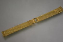 A substantial 18ct gold fine meshlink bracelet watch strap, with engine turned clasp. Length