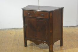 A George III inlaid mahogany tambour commode, the shaped moulded top with canted corners, above a