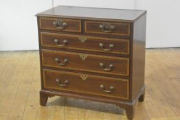 A small George III satinwood inlaid mahogany chest of drawers, the moulded and crossbanded