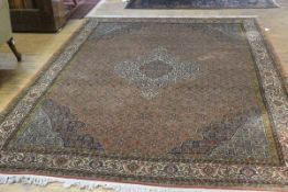 A Bijar carpet, finely knotted, with centre medallion enclosed within a floral scalloped field,