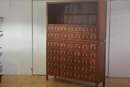 A large Chinese red lacquer two-part medicine cabinet, the upper section with recess and drawers,
