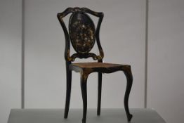 A 19th century mother-of-pearl inlaid and painted papier mache lady's drawing room chair, the oval