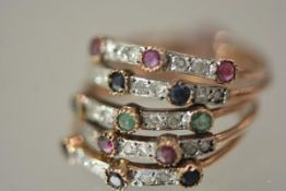 A gem-set stacking ring of five bands, each set with round brilliant-cut diamond points spaced by