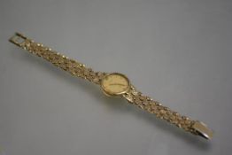 A lady's 9ct gold Swiss wristwatch, the dial signed "Q", gilt dial with baton numerals, on a fancy