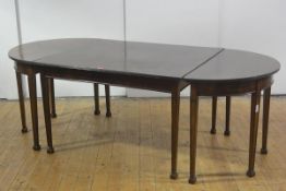 A George III style mahogany D-end dining table, the top with reeded edge, raised on channelled