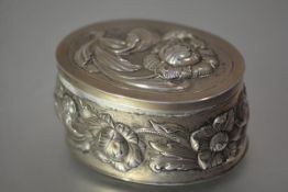 A German 800 silver box, c. 1890, oval, repousse with flowers in early 18th century style, with
