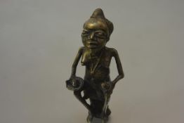 An African bronze of a woman seated on a stool, a dish in her right hand. 20.5cm