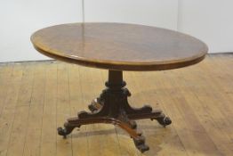 A mid-Victorian burr walnut supper table, the oval quarter-veneered top raised on a well-carved