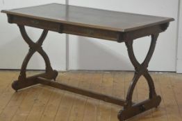 A Gothic Revival walnut writing table, mid-19th century, the rectangular, leather-inset, moulded top