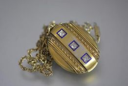 A striking diamond-set and enamelled gold locket, late 19th century, oval, mounted with a line of