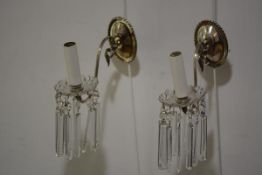 A pair of silvered metal and cut-glass wall sconces, c. 1920, each with oval backplate issuing a