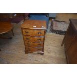 A 19thc style walnut chest of drawers, the plain top with moulded edge, four long drawers raised