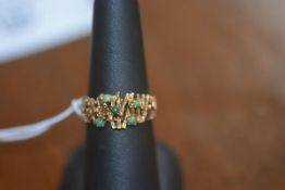 A lady's vintage dress ring set with small jade beads, on 9ct gold band