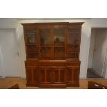 A yew wood breakfront bookcase cabinet, in 18th century style, the moulded top above four astragal