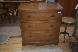 A 19thc bow fronted mahogany chest of drawers, the plain top with reeded edge, three long drawers on