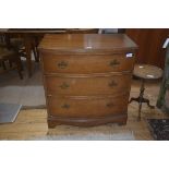 A 19thc bow fronted mahogany chest of drawers, the plain top with reeded edge, three long drawers on