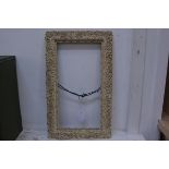 An ornate moulded gilt frame, 27cm x 51.5cm